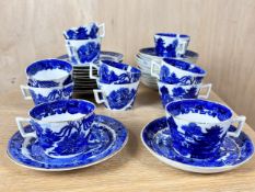 A collection of eleven blue and white willow pattern cups and saucers with side plates.