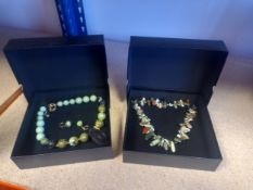 Two boxed necklaces; one with spherical coloured glass beads, the other with natural semi precious