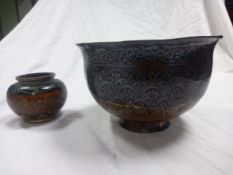 A 19th century Qajar bronze and copper bowl on a narrow flared foot, along with a small Japanese