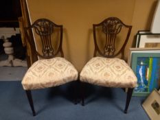 A pair of 19th century mahogany Hepplewhite style dining chairs.