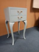 A contemporary painted bow fronted bedside tabe with two drawers on cabriole supports. H. 67cm W.
