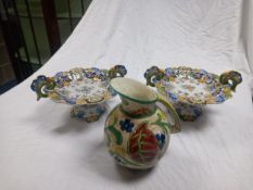 A pair of tin glazed continental majolica tazzas and a majolica style Falcon Ware Sanora jug. Dia
