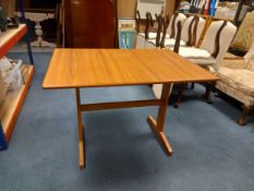A 1970's vintage dining table with composite laminate top on beech trestle supports. L.106 W.74cm