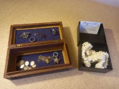 A miscellaneous collection of jewellery to include rings, earrings, bracelets in a carved inlaid box