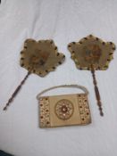 A pair of 19th century hand-held needlework face screens set on turned wooden handles, along with