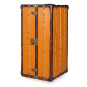 LOUIS VUITTON: AN ANTIQUE WARDROBE TRUNK IN ORANGE 