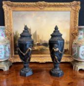 A PAIR OF BRONZE URNS AND COVERS DECORATED WITH DANCING GIRLS
