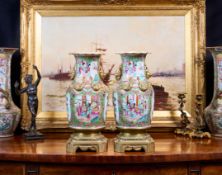 A PAIR OF LATE 19TH CENTURY CHINESE FAMILLE ROSE PORCELAIN AND ORMOLU MOUNTED VASES