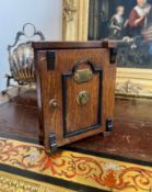 A 19TH CENTURY OAK JEWELLERY BOX DESIGNED AS A SAFE