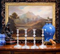 A SET OF FOUR LATE 19TH / EARLY 20TH CENTURY SILVER PLATED CANDLESTICKS BY WILLIAM HUTTON & SONS