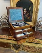 A LATE 19TH CENTURY WALNUT CANTEEN OF SILVER PLATED CUTLERY
