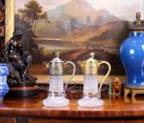 A PAIR OF STERLING SILVER GILT MOUNTED AND CUT GLASS CLARET JUGS, LONDON, 1885