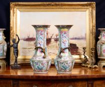 A PAIR OF LATE 19TH CENTURY CHINESE FAMILLE ROSE PORCELAIN AND ORMOLU MOUNTED VASES