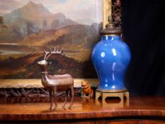 A LATE 19TH / EARLY 20TH CENTURY QAJAR DAMASCENED MODEL OF A STAG