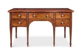 A GEORGE III MAHOGANY SERPENTINE SIDEBOARD