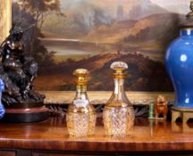 A SET OF TWO LATE 19TH CENTURY BOHEMIAN CUT, ETCHED AND FLASHED AMBER GLASS DECANTERS