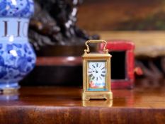 A LATE 19TH CENTURY FRENCH PORCELAIN MOUNTED MINIATURE CARRIAGE CLOCK