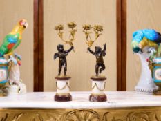 A FINE PAIR OF MID 19TH CENTURY GILT AND PATINATED BRONZE CHERUB CANDELABRA