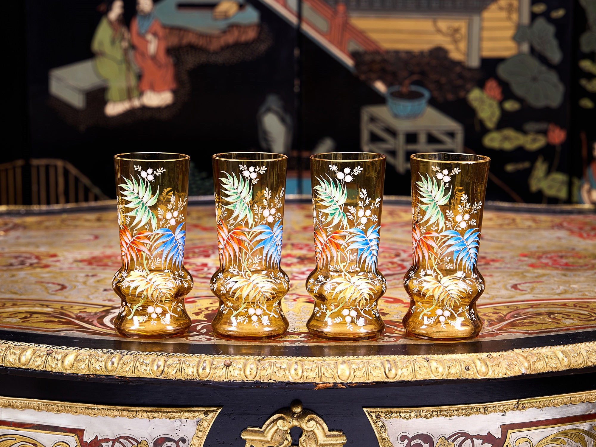 A SET OF FOUR ENAMELLED GLASS VASES