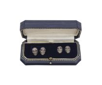 A PAIR OF GOLD AND DIAMOND ENCRUSTED SKULL CUFFLINKS