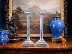 A PAIR OF LATE 19TH CENTURY SILVER PLATED CORINTHIAN COLUMN CANDLESTICKS
