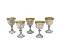 A SET OF FIVE STERLING SILVER AND VERMEIL WINE GOBLETS