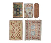 A KILLIM WOOL RUG AND FOUR OTHERS