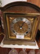 A WOODEN CASED ELLIOTT MANTLE CLOCK RETAILED BY GARRARD AND CO LIMITED WITH KEY AND BOOKLET