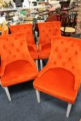 A SET OF FOUR MODERN UPHOLSTERED ORANGE CHAIRS
