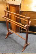 AN EDWARDIAN MAHOGANY TOWEL RAIL