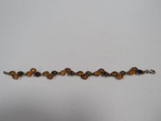 A SILVER MULTICOLOURED AMBER SET PANEL LINK BRACELET