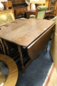 A LARGE OAK DROPLEAF TABLE