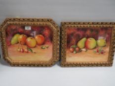 TWO LARGE GILT FRAMED PORCLIEN PLAQUES DEPICTING STILL LIFE FRUIT