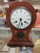 AN EDWARDIAN WOODEN CASED BALLOON SHAPED MANTLE CLOCK KEY (NO PENDULUM)