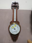 A VINTAGE CARVED OAK BAROMETER