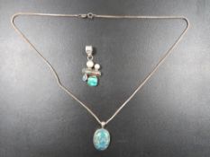 A SILVER OPAL EFFECT PENDANT ON CHAIN TOGETHER WITH A MODERN SILVER DESIGNER STYLE PENDANT