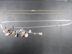 A SILVER CHARM BRACELET AND TWO SILVER NECK CHAINS