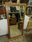 A MODERN OAK FRAMED RECTANGULAR MIRROR 119 x 60 cm