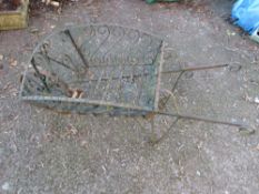 A WROUGHT IRON DECORATIVE PLANTER DEPICTING A WHEELBARROW