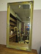 A LARGE MODERN GILT FRAMED RECTANGULAR MIRROR 136 x 76 cm