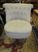 A MODERN UPHOLSTERED BEDROOM CHAIR