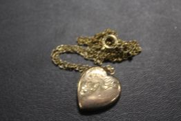 AN ANTIQUE LOCKET MARKED 9CT BACK AND FRONT