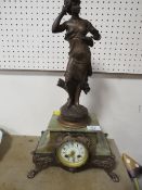 A FIGURAL CLOCK ON ONYX AND GILT METAL BASE