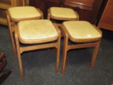 A SET OF FOUR RETRO MID-CENTURY STOOLS