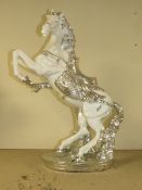 A DECORATIVE SILVER AND WHITE REARING HORSE MODEL