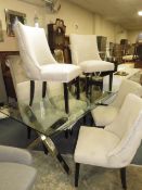 A LARGE MODERN GLASS TOPPED TABLE WITH SIX UPHOLSTERED CHAIRS