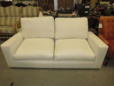 A MODERN WHITE UPHOLSTERED SETTEE
