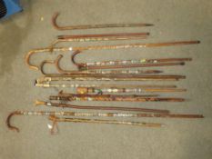 A SELECTION OF WALKING STAFFS WITH BADGES