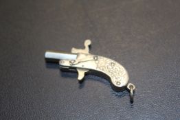 A VINTAGE MINIATURE WHITE METAL PISTOL