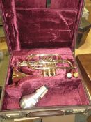 A CASED BESSON HORN WITH MUTE